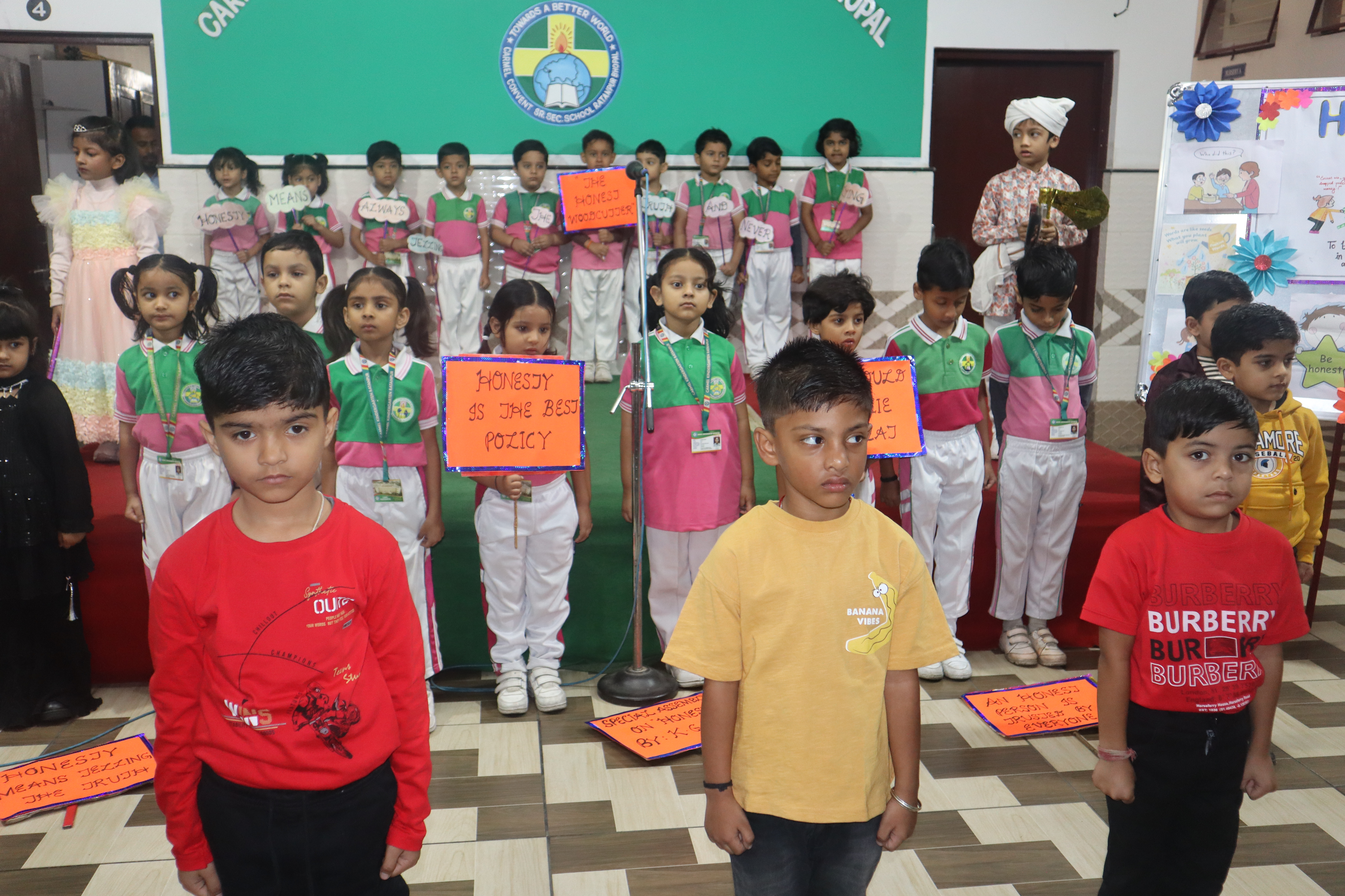 Students presenting a special assembly on honesty with hand made placards